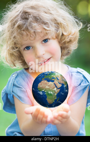 Earth in children`s hands Stock Photo